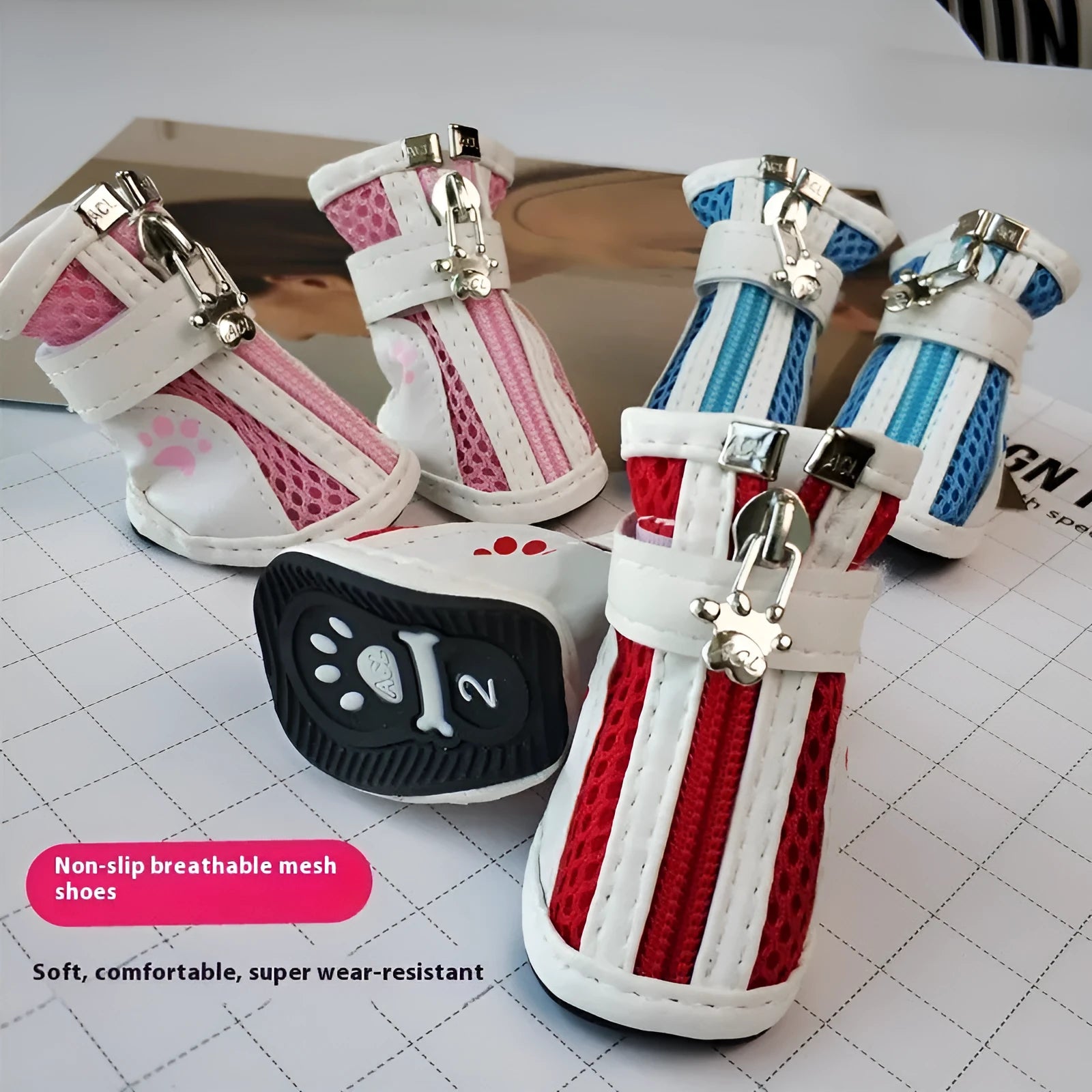 Four blue cloth dog shoes with zipper closures, shown on a small dog's paws.