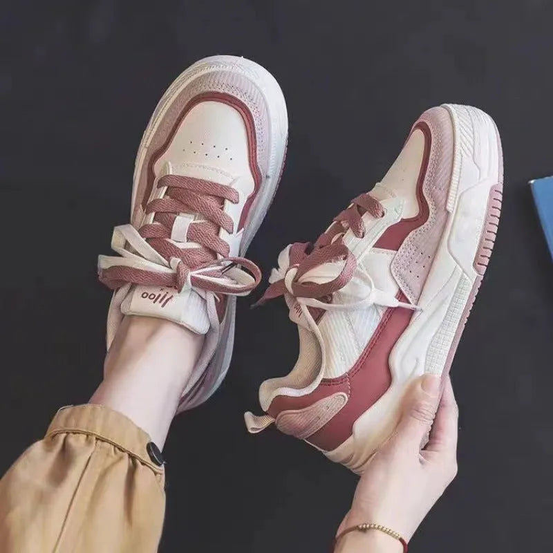 Pink and beige low-top sneakers with rubber soles and height-increasing design