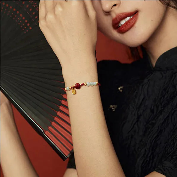 Women's adjustable 925 silver bracelet with Hetian jade and cinnabar red rope design on wrist