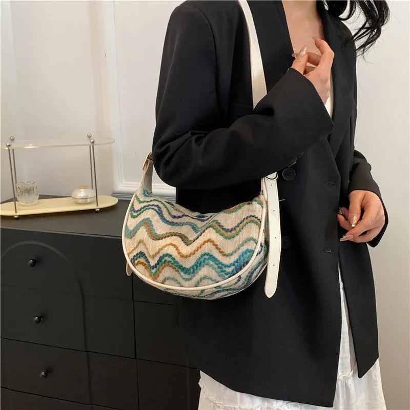 Straw woven crossbody bag showing woven texture and interior phone compartment