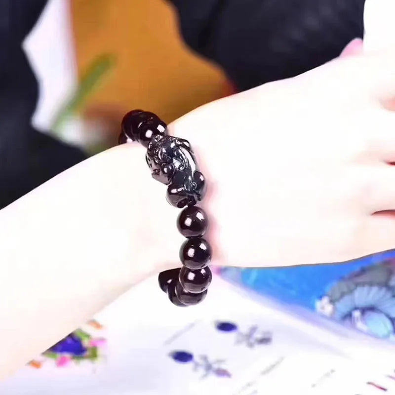 Natural obsidian eye crystal bracelet showing characteristic patterning on beads