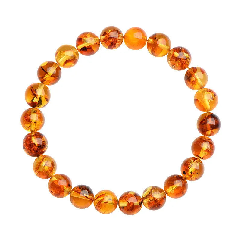 Yellow piebald amber bracelet with geometric beads showing natural flower spot patterning