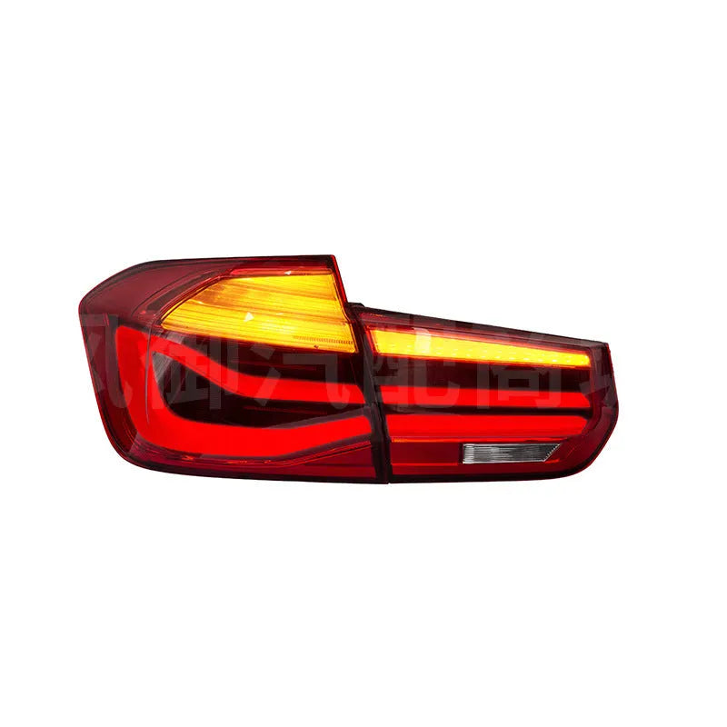 BMW 3 Series modified LED tail light assembly in smoked black finish, showing streamer light pattern.