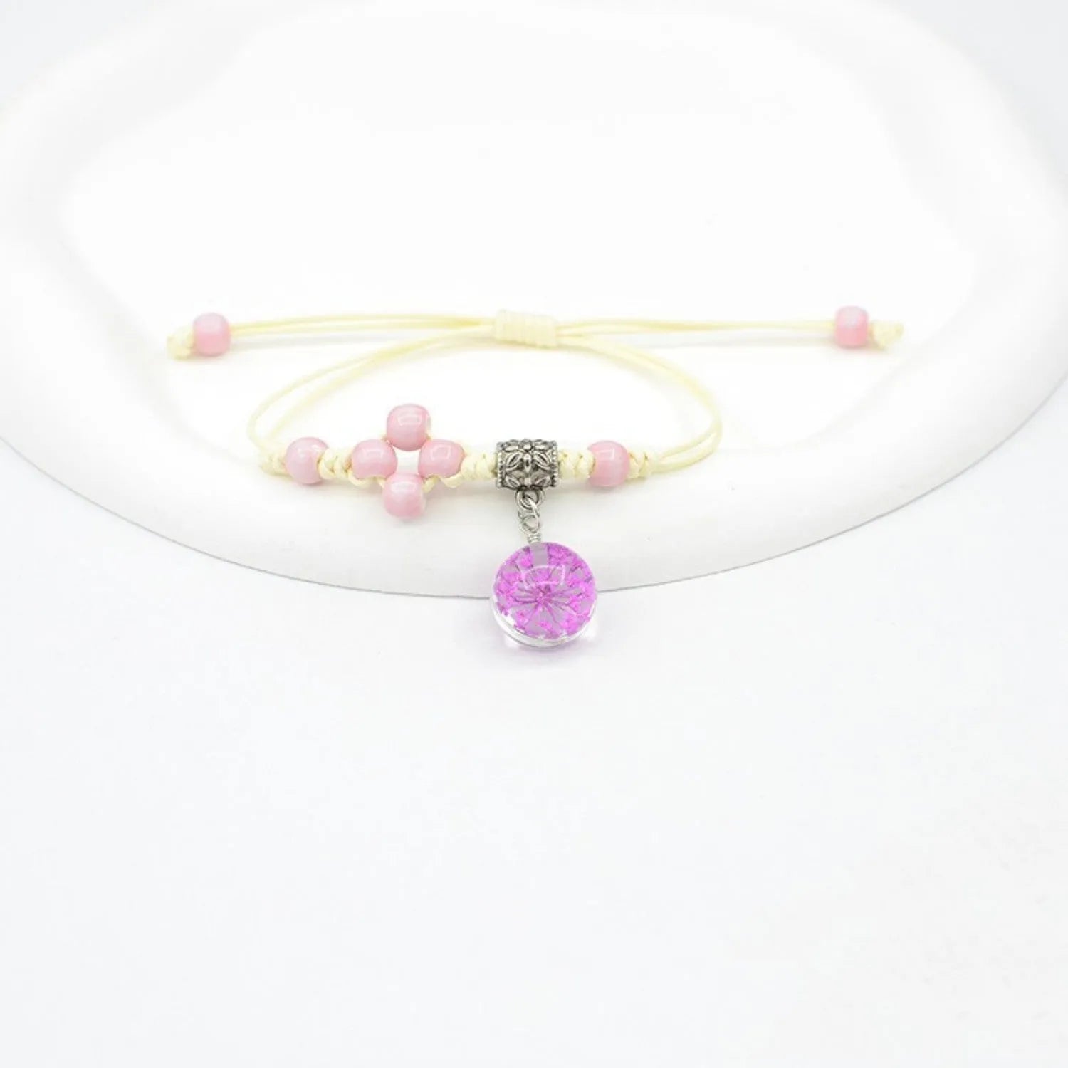 Hand-woven glass bracelet with 1.4cm beads containing real dried flowers in various colours