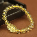 Yellow artificial crystal Pi Xiu bracelet on a leather cord in Chinese national style.