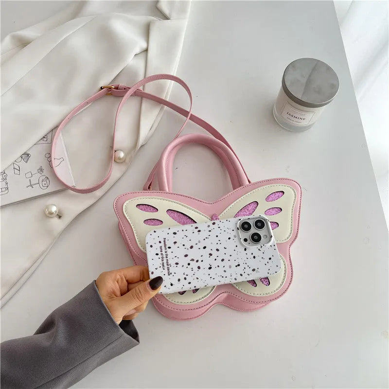 White square women's crossbody bag made of PU leather with contrast colour trim on a table.