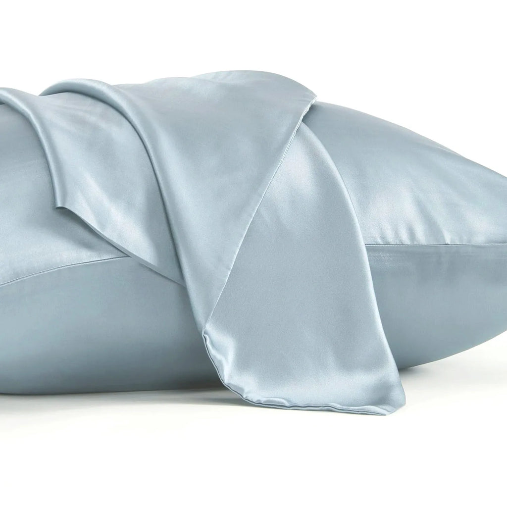 Solid colour mulberry silk envelope pillowcase in dark grey on a bed.