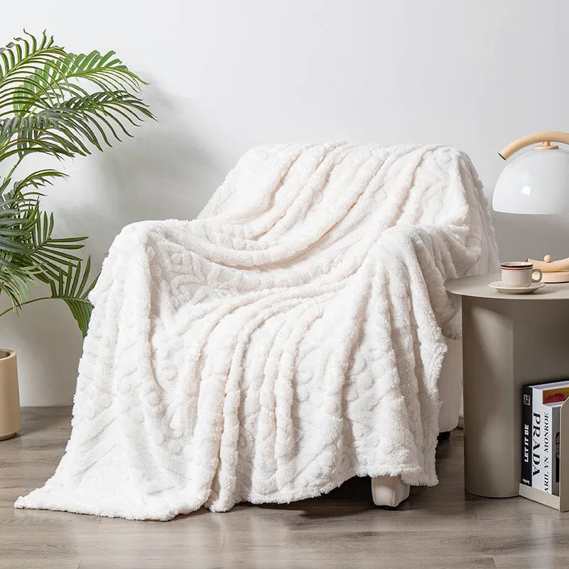 Shu Cotton Velvet Jacquard blanket in fog blue with a woven plant flower pattern, laid flat.