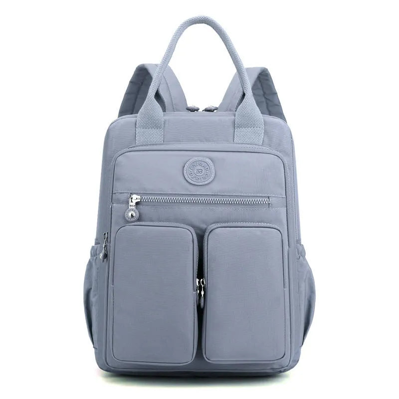 Women's waterproof nylon travel backpack with multiple internal compartments in various colours