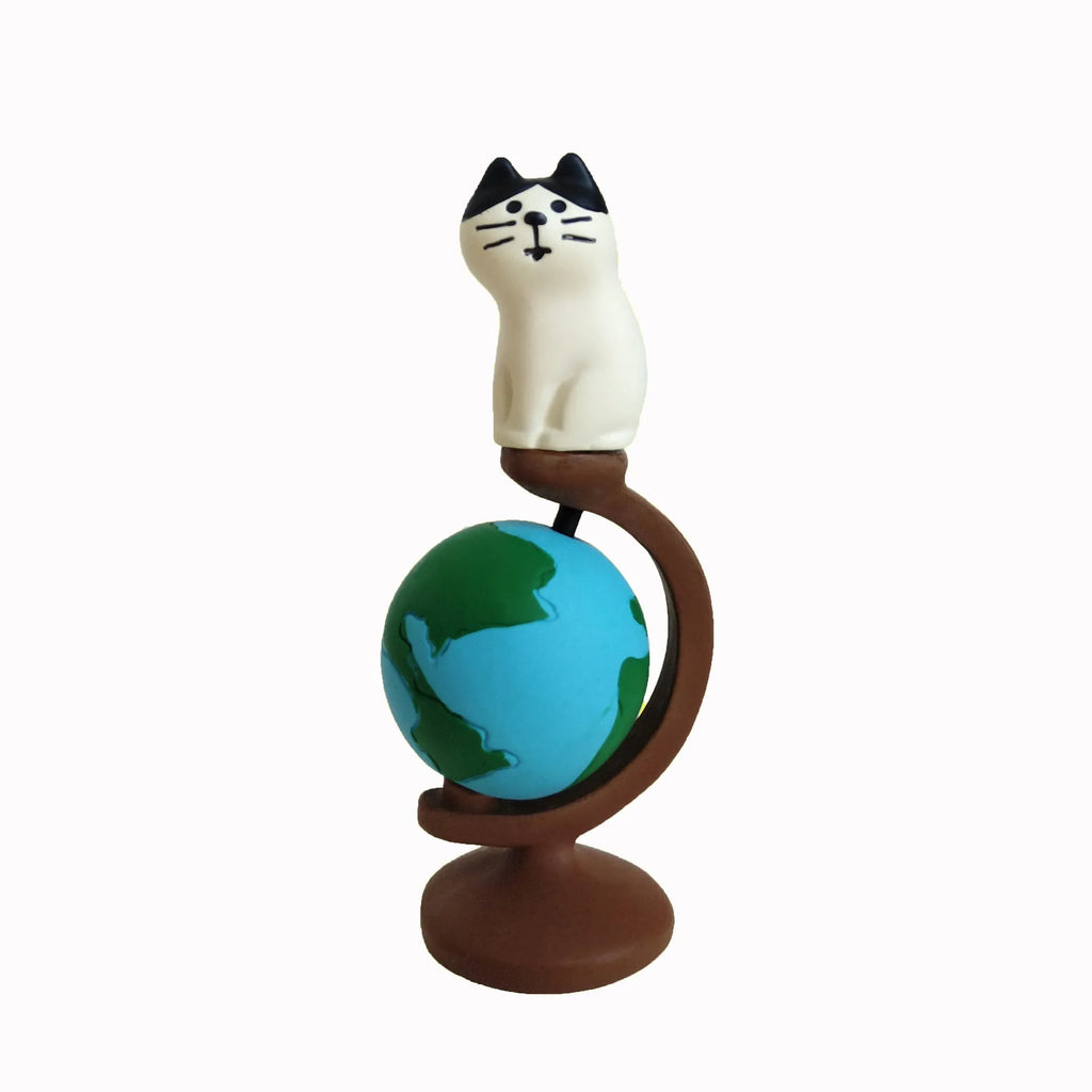 Cartoon resin craft sculpture of a cat dressed as the Statue of Liberty, holding a globe.