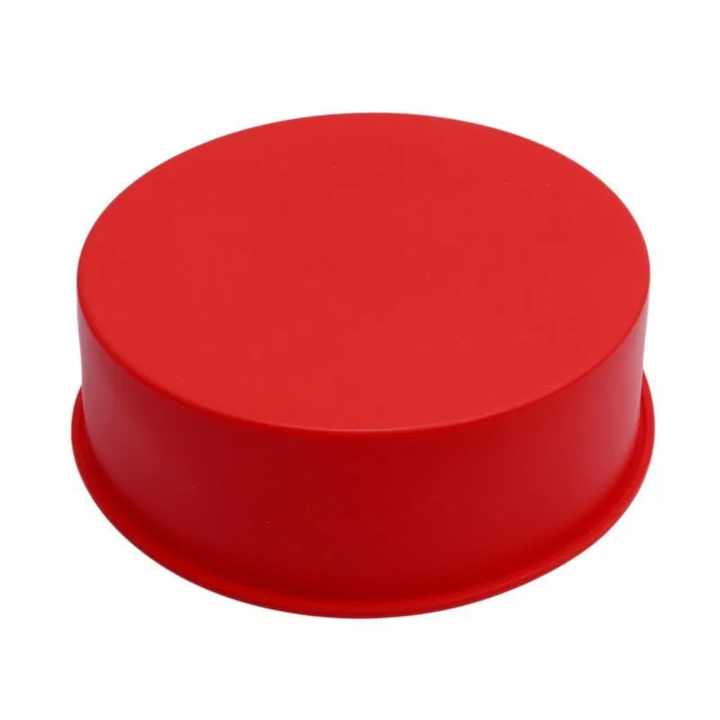 Red round silicone cake mould on a baking tray showing 8 inch size with smooth interior