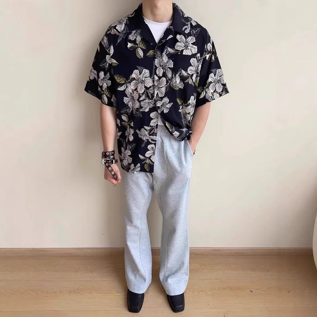 Black men's short sleeve shirt with floral print, Cuban collar, and loose cardigan fit.