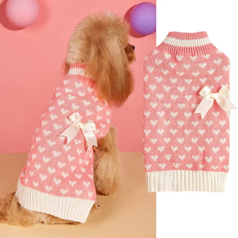 Dog wearing red love heart patterned sweater in acrylic knit fabric