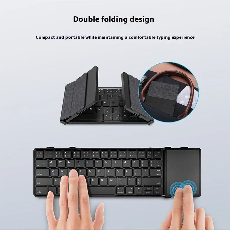 Black folding Bluetooth keyboard with touchpad option next to a mobile phone