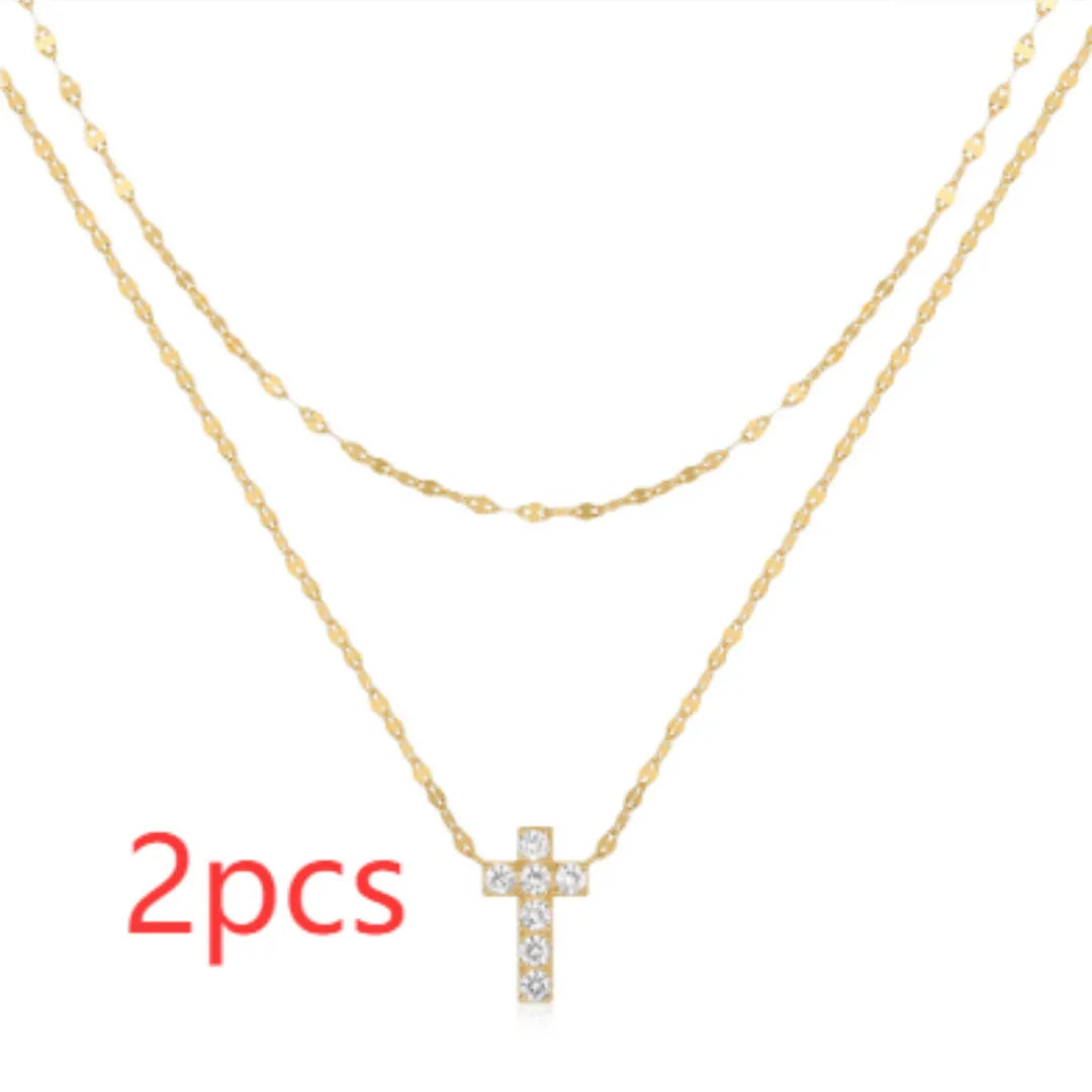 Double layer geometric twin diamond cross pendant on a sterling silver clavicle chain.