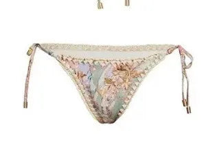 Creamy-white floral women's bikini set with matching skirt on beach