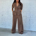 Brown men's two-piece slim fit suit with long sleeves and matching trousers on a hanger.