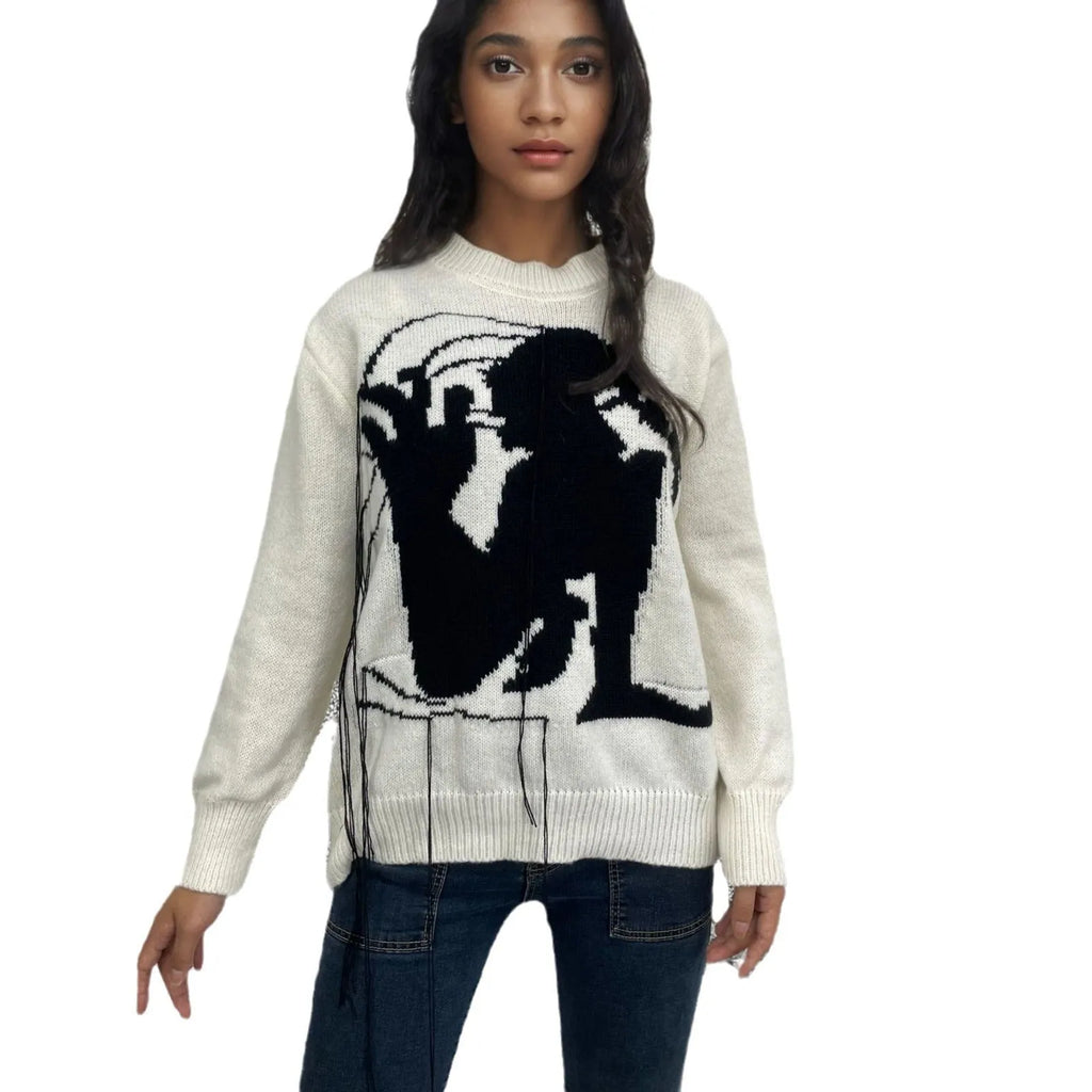 Grey women's loose alpaca wool sweater with tassel detail and abstract pattern, round neck.