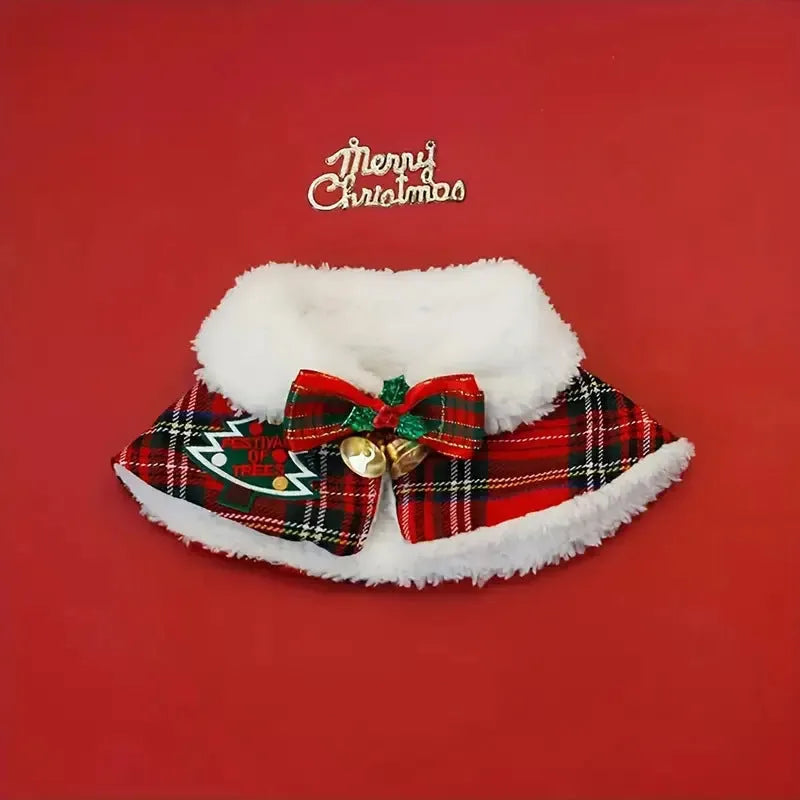 Polyester pet scarf cloak on a dog, showing a red background with a festive snowflake bell design.