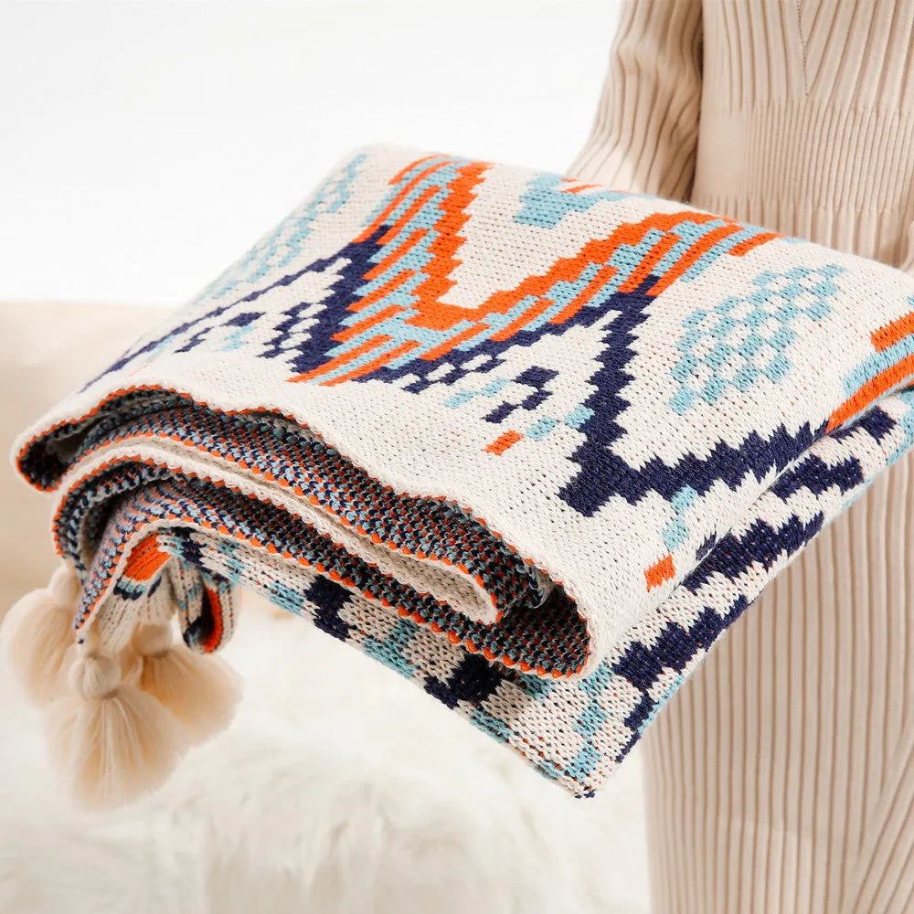 Acrylic sofa blanket with tassel fringe in geometric pattern, showing 130 cm width measurement