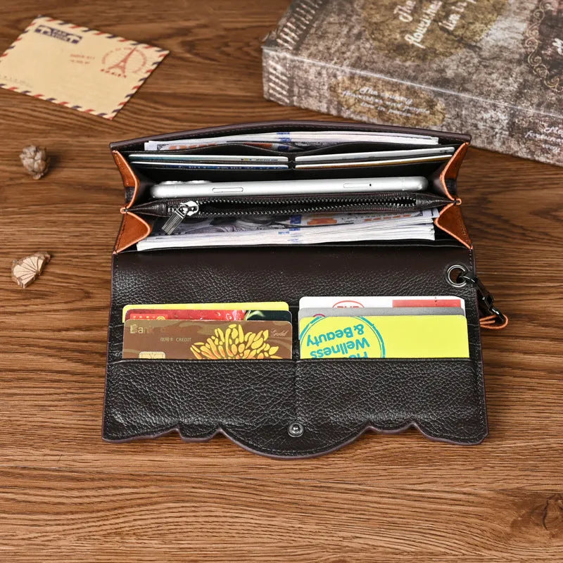 Women's brown tri-fold leather wallet with embossed floral pattern showing open compartments