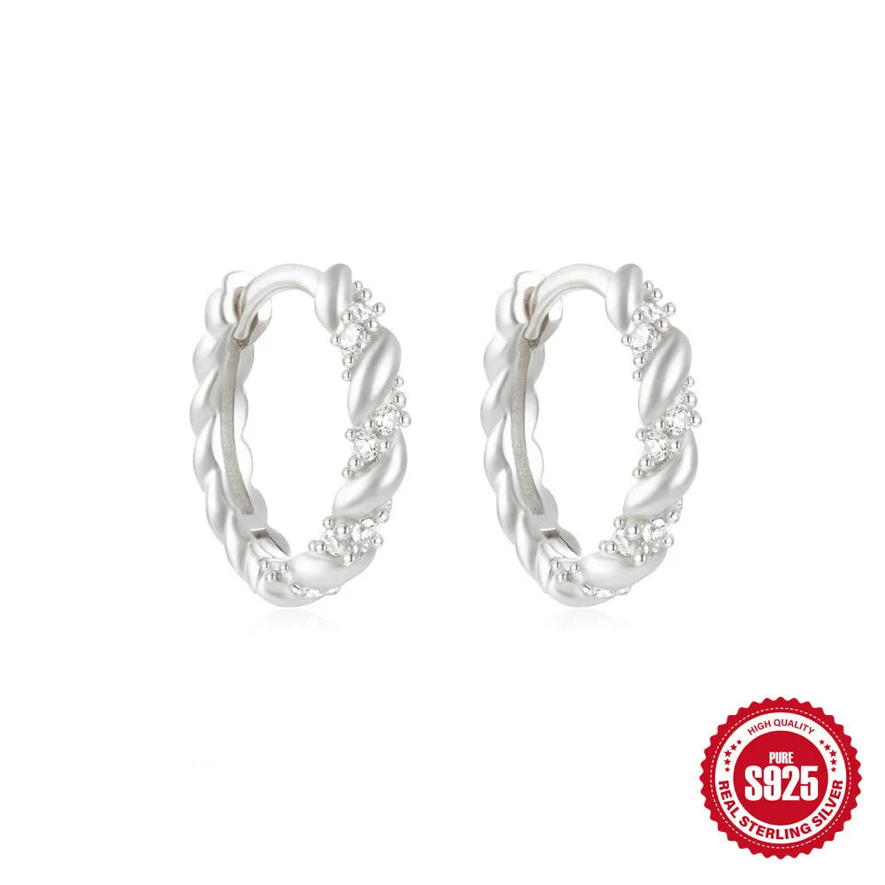 Small round geometric sterling silver stud earrings in gold and silver electroplated finishes.