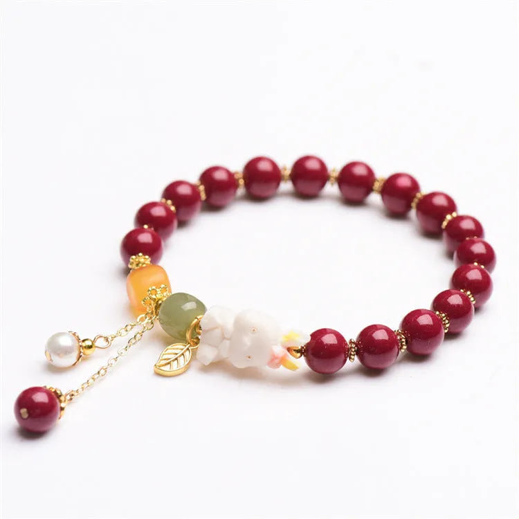 Natural red cinnabar bracelet for women featuring a carved rabbit design, shown in 8mm and 10mm width options.