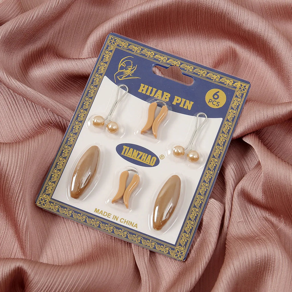 Plastic scarf clip with oval meander pattern and resin drip finish in five colours including black, gray, white, brown, and pink.