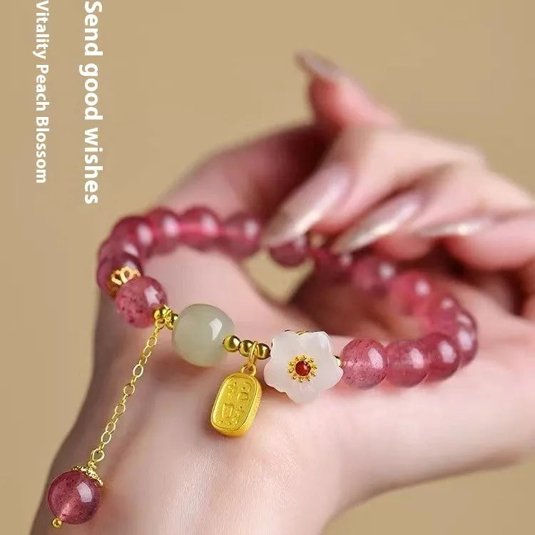 Handcrafted strawberry quartz crystal bracelet with Hetian jade peach blossom charms for women