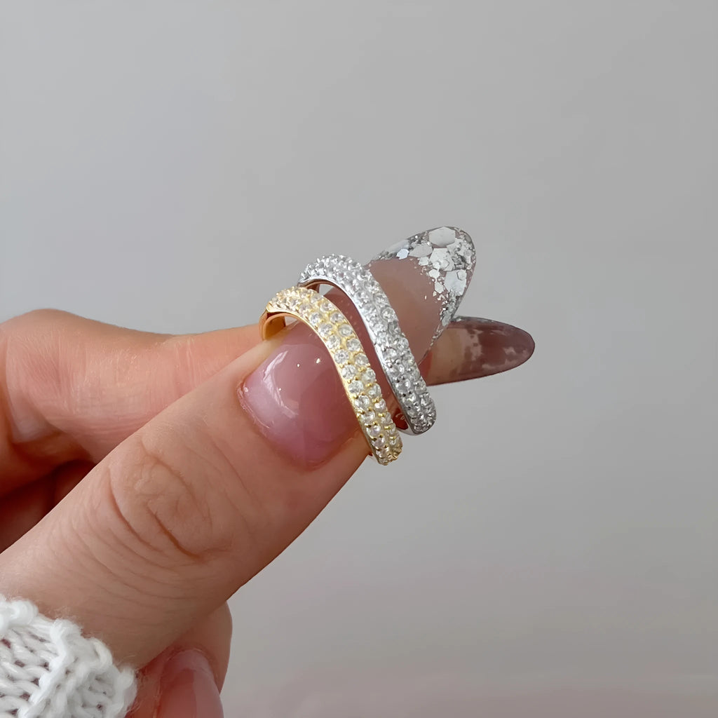 Female S925 sterling silver snake-shaped ring with zircon inlay in platinum finish on white background