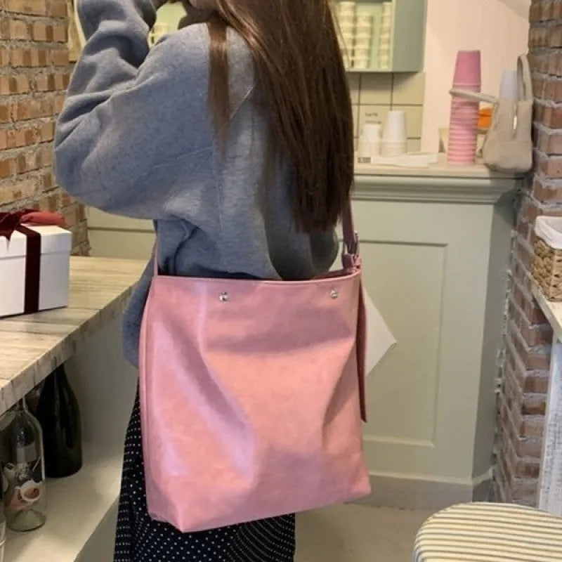 Pink corduroy one-shoulder commuter bag with dimensions 39cm by 32cm