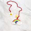 Handmade crocheted rainbow flower car pendant in wool with colourful avocado, pink, and red patterns