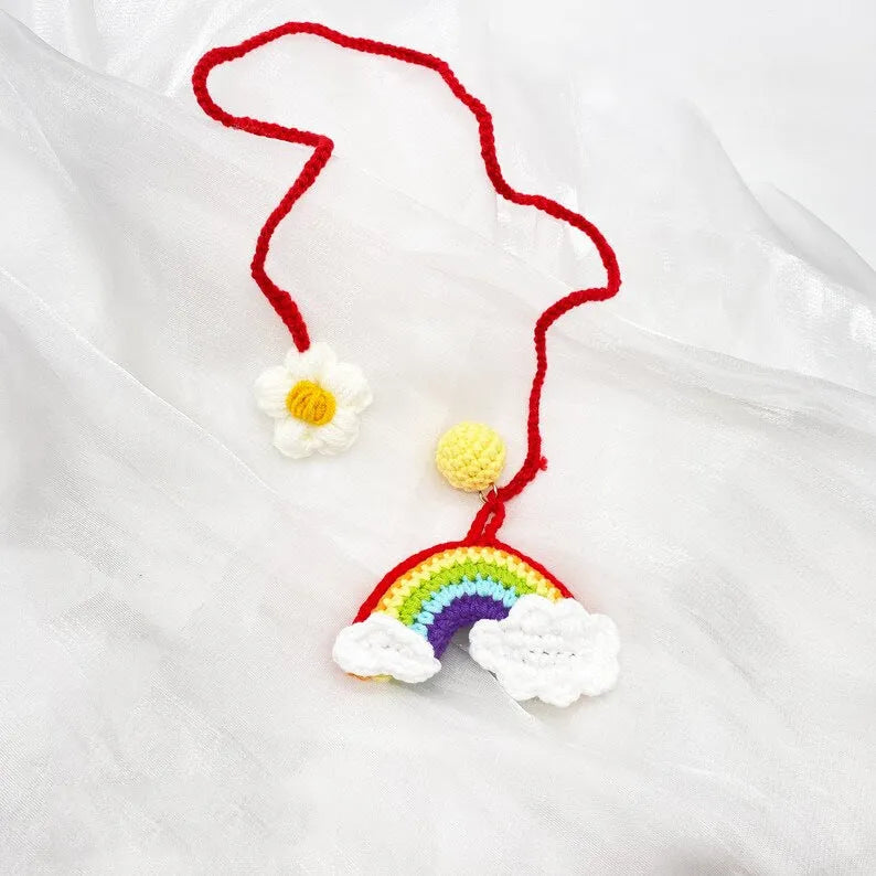 Handmade crocheted rainbow flower car pendant in wool with colourful avocado, pink, and red patterns