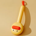Small yellow duck-shaped comb for pet grooming with needle points and floating hair removal device
