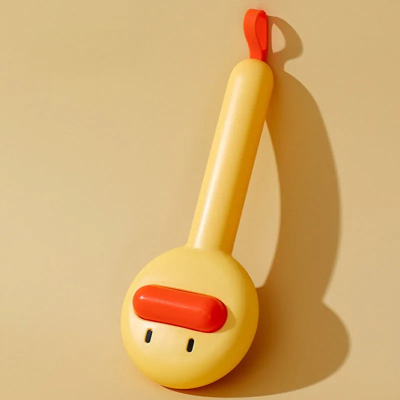 Small yellow duck-shaped comb for pet grooming with needle points and floating hair removal device