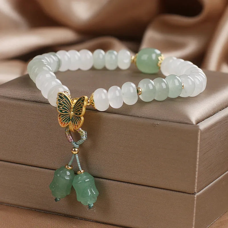 Green crystal women's bracelet with abacus beads, butterfly tassel, rhinestones and pearls