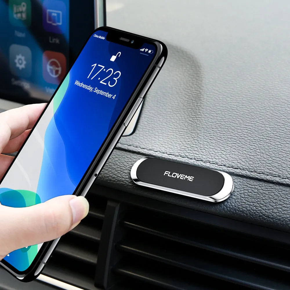 Black magnetic car phone holder with vent clip and silver iron plate for dashboard mounting
