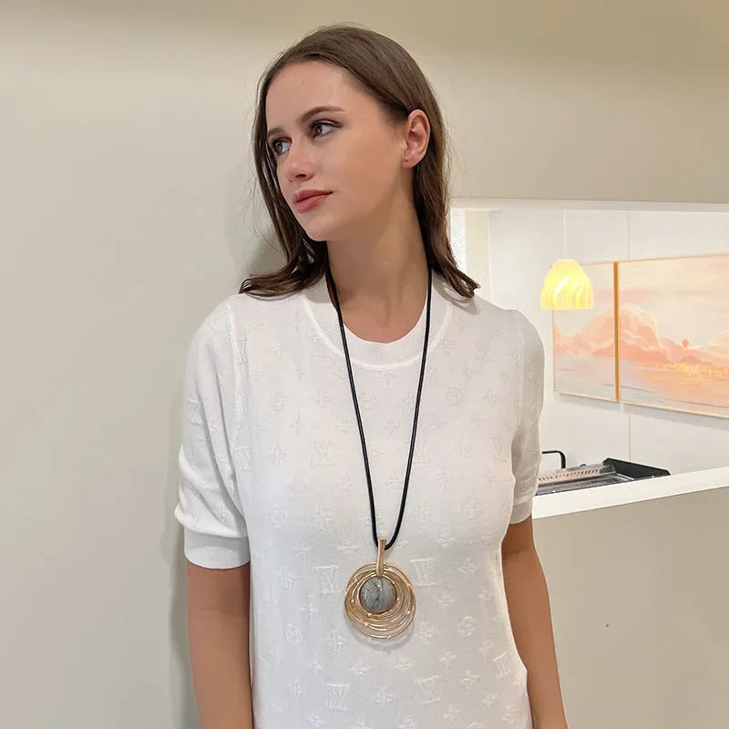 Gold tone geometric plaid pendant on a textured snakeskin wax rope chain necklace, adjustable from 51cm to 80cm.