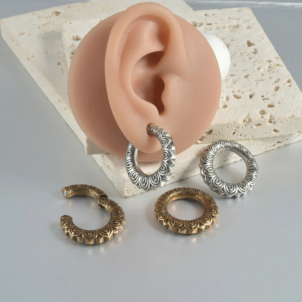 A pair of large antique silver alloy earrings featuring a hollow out geometric dragon design.
