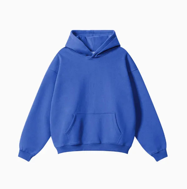 Man wearing a loose-fit grey terry cotton hooded sweater with drop-shoulder sleeves.