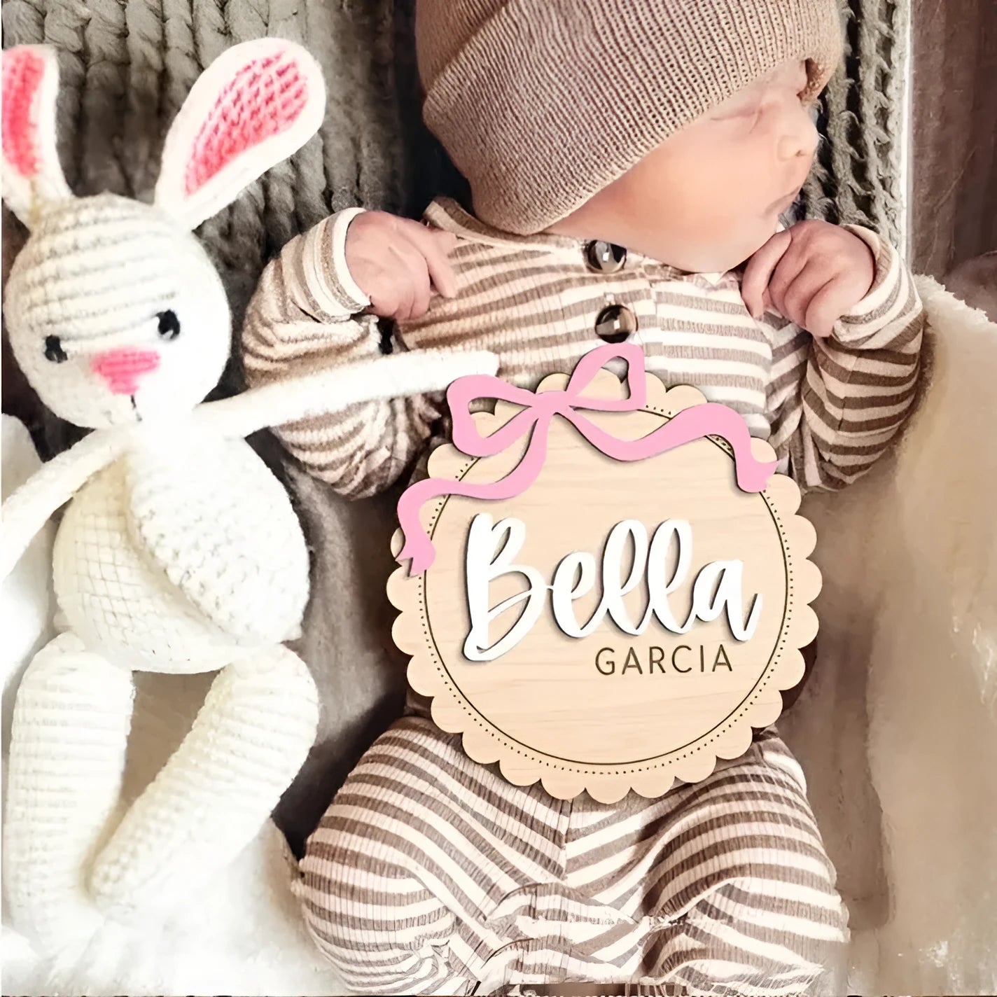 A square wooden ornament personalised with a baby's name for nursery decoration or photo prop.