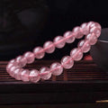 Women's strawberry quartz bracelet with polished beads in 6mm, 8mm, or 10mm sizes