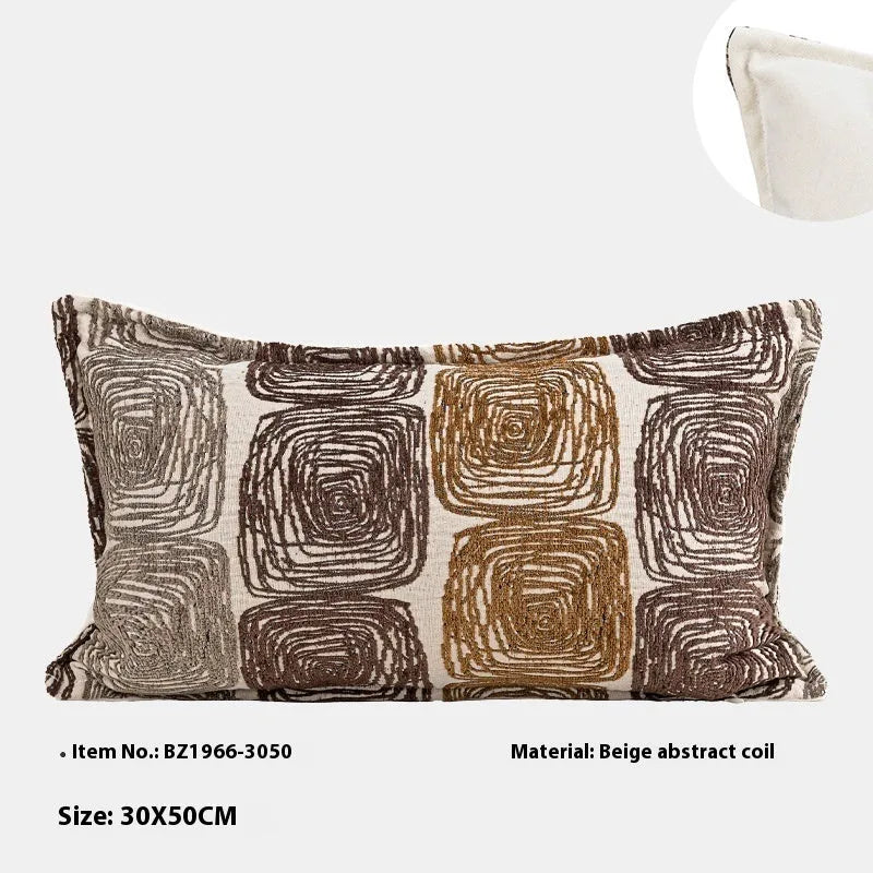 Abstract coil pattern pillow cover in cream and coffee colours on grey sofa