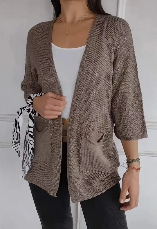 Women's army green waffle weave cardigan coat with nine-quarter length sleeves and pockets.