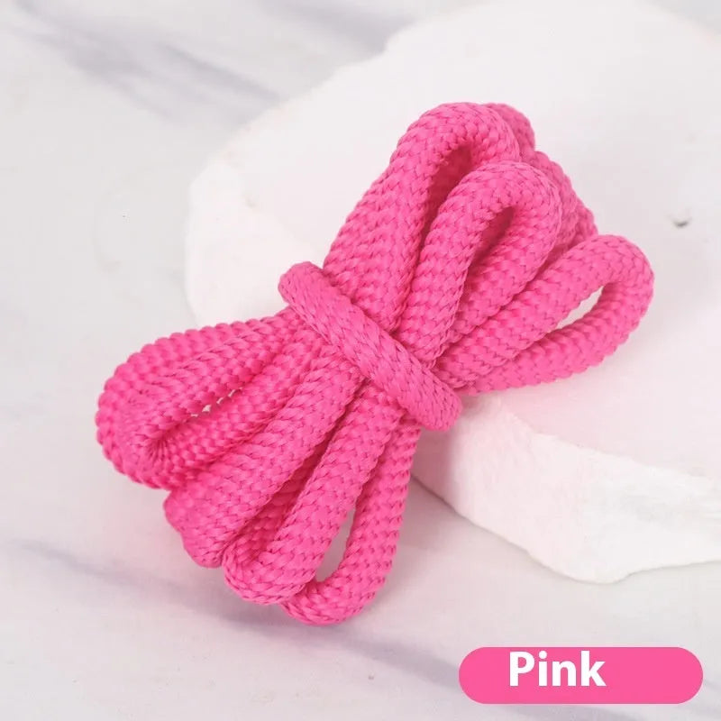 Oval cross-section shoelace adapter rope in various colours, shown next to a trainer and sweatshirt.
