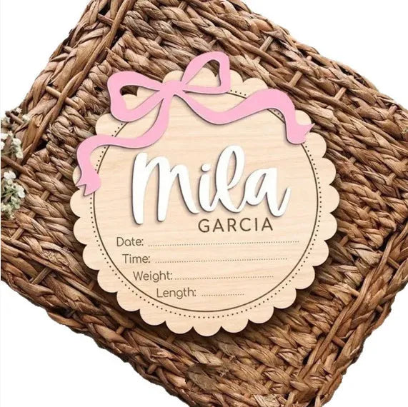 A square wooden ornament personalised with a baby's name for nursery decoration or photo prop.