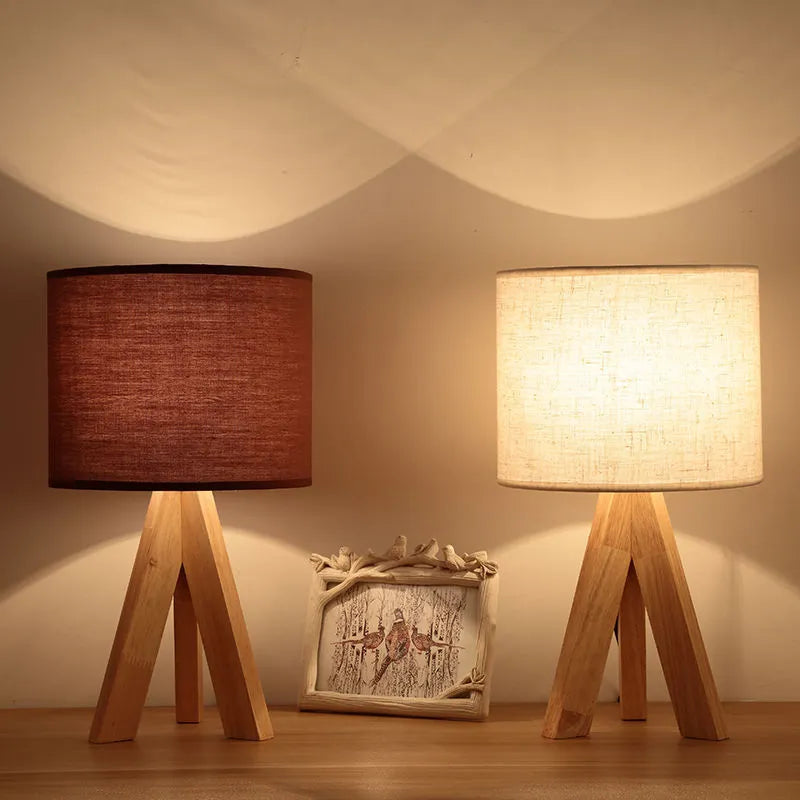Japanese style solid wood table lamp with fabric lampshade in linen trumpet colour on bedside table