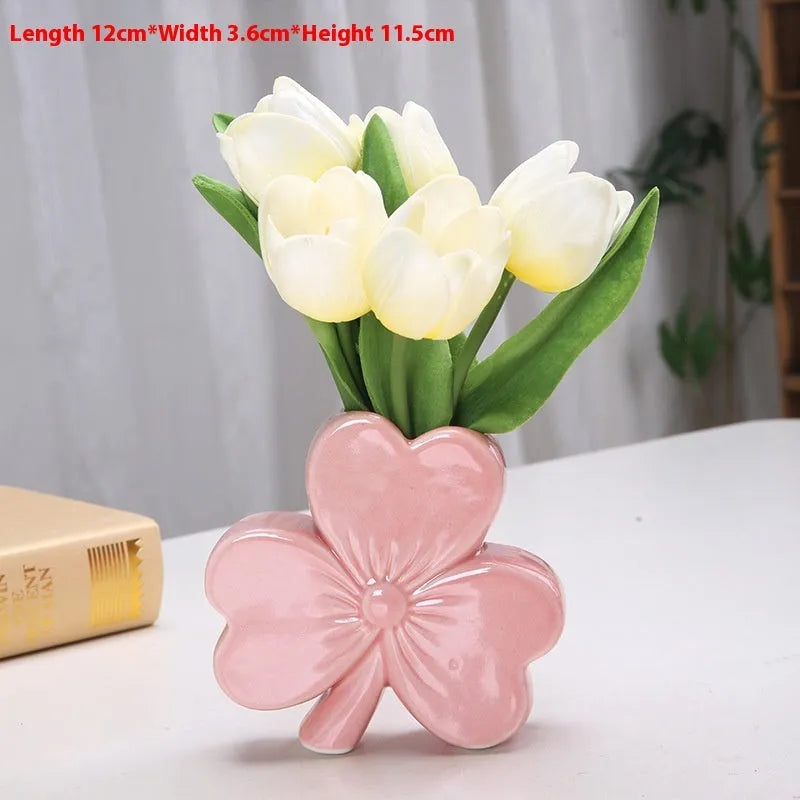European style white porcelain ceramic vase on a desktop, shown in light green colour.