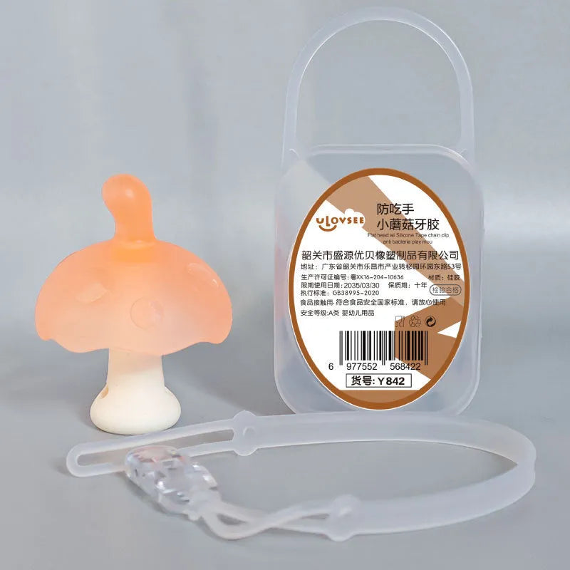 Small mushroom-shaped silicone chewing gum on a chain, in pink or nano colour, inside a transparent box.