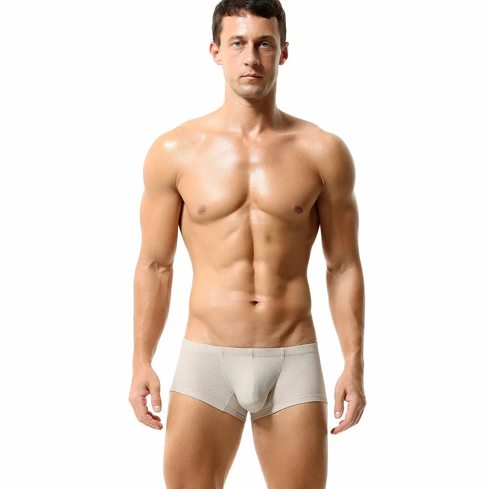Men's solid colour low-waist nylon boxer shorts on a white background.
